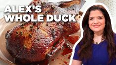 a woman standing in front of a roasting turkey on a plate with the words alex's whole duck