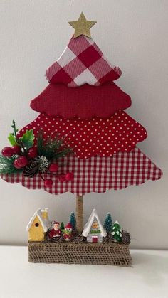 a red and white christmas tree on top of a table