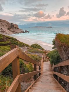 a wooden walkway leading to the beach