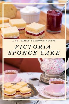 the victoria sponge cake is served on a tray with tea cups and saucers next to it