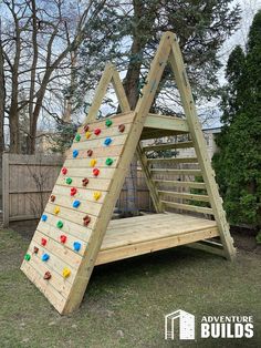 a wooden climbing wall in the backyard