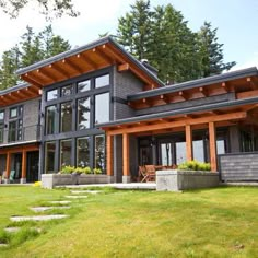 a large house with lots of windows in the front yard