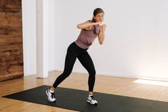 a woman in a yoga pose on a mat