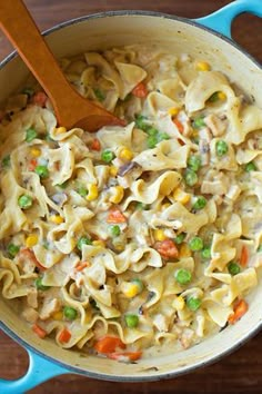 two pictures of pasta and vegetables being cooked in a skillet