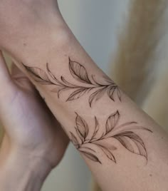 a woman's arm with a flower tattoo on it