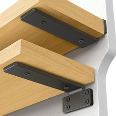 two brackets are attached to the side of a wall with wood and metal trims