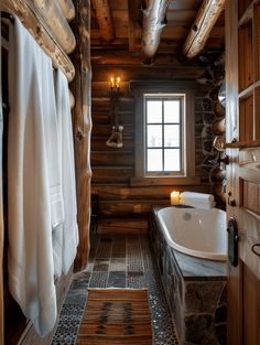 the bathroom is decorated in rustic wood and has a large bathtub next to it