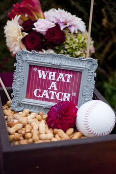 a box filled with nuts and flowers next to a sign that says what a catch