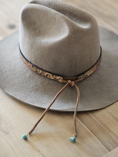 add instant cool to your favorite  felt or cowboy hat! I hand make every hat band to order using top grade leather. 1/2" inch wide hand tooled floral pattern antique brass eyelets stained light brown/ beige  antique one size fits all ( 55 to 66 cm) with adjustable strong suede strap hand beaded turquoise stone ends Personalization: I will stamp your 2 initials beside the antique gold eyelet using my 1/4'' inch uppercase alphabet font just write them in the personalization box at checkout All lea Felt Hat Band, Hat Bar, Uppercase Alphabet, Hat Bands, Alphabet Font, Western Hat, Leather Hat, Head Gear, Floral Hat