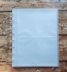 a white notebook sitting on top of a wooden table