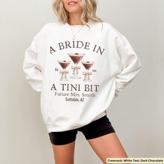 Celebrate the soon to be bride's love for espresso with this Personalized Espresso Martini Sweatshirt! Perfect for engagement party, bridal showers or cocktail-themed bachelorette parties, this custom sweater, available in both hoodie and sweatshirt styles, is a stylish gift for the espresso-loving bride. It also makes a thoughtful bridesmaids' gift, adding a fun twist to the celebration. Explore our full range of products including shirts, sweatshirts, trucker hats and more by visiting our stor Tini Bachelorette, Bride Crewneck, Custom Sweaters, Cocktail Club, Personalized Bride, Espresso Martini, Bridal Shower Theme