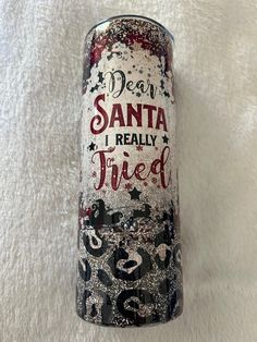 a can of soda sitting on top of a white blanket with writing in red and black