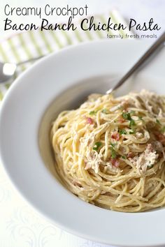 a white bowl filled with pasta and chicken