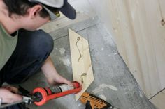 a man is working on some wood planks with a drill and screwdriver