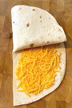 a tortilla with cheese is on a cutting board