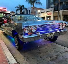 an old car is parked on the side of the road