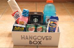 a box filled with drinks and snacks on top of a tiled floor