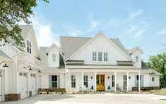 a large white house with lots of windows on the front and side of it's doors