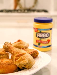 fried food on a plate next to a jar of argo