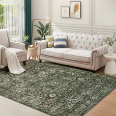 a living room with two couches and a rug on the floor in front of a window