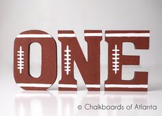 the word one is made up of footballs on it's sides and sits in front of a white background