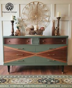 an old dresser is painted green and brown