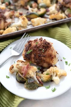 a close up of a plate of food with broccoli and chicken on it