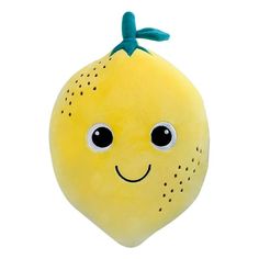 a yellow stuffed lemon with a green bow on it's head and eyes are smiling