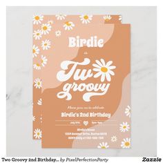 an orange and white floral birthday party card with daisies on the bottom, in front of a marble background