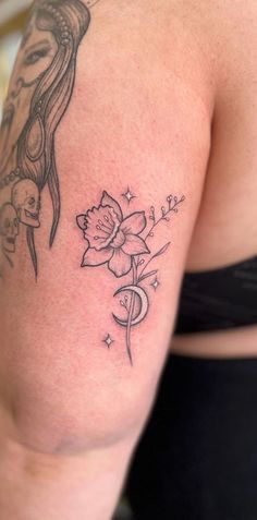 a woman with a flower tattoo on her arm