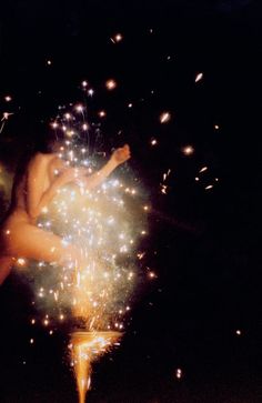 a person holding a sparkler in their hand