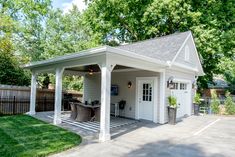 a small white house with a covered patio