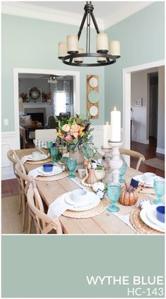 the dining room table is set with plates and place settings