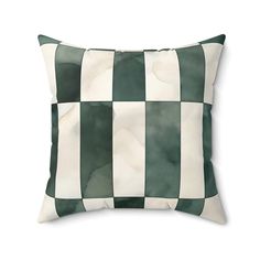 a green and white checkered pillow on a white background