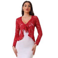 Opt for a decadent cover-up for your special occasions with this lace shrug. This stretchy lace cardigan offers the perfect balance to longer layers in a waist-defining cut with a tie front. Constructed in a classic shrug silhouette, this charming piece benefits from an open neck and elegant long sleeves with ruffles. Intricate design details include a satin binding around the front and hem and a floral lace design. Paired with a sleeveless dress, spaghetti strap, tank top, or simple off-shoulde Cropped Shrug, Lace Shrug, Lace Bolero, Bolero Shrug, Rib Knit Cardigan, Lace Tie, Long Sleeve Knitted Cardigan, Women's Tie, Lace Cardigan