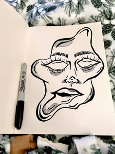 a drawing of a woman's face on top of a sheet of white paper