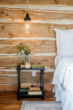 a bed in a room with wooden walls