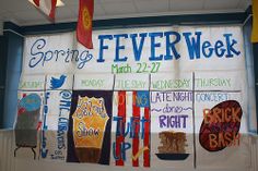 a bulletin board with some writing on it and flags hanging from the wall behind it