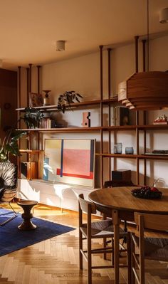 a living room filled with furniture and a flat screen tv on top of a wooden table