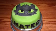 there is a green cake with black frosting on the top that says mateo