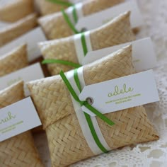 small wrapped cookies with green ribbon tied around them on a tablecloth covered table cloth