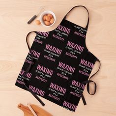 an apron with the words waxing on it next to some eggs and spoons