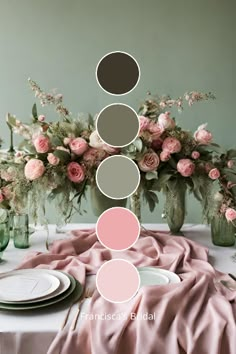 the table is set with pink and green flowers in vases, plates, and napkins