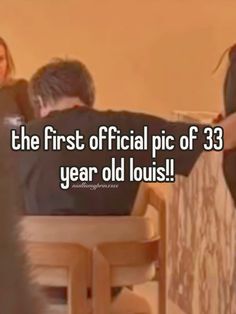 the first official pic of 33 year old louis is shown in this image with two people sitting at a table