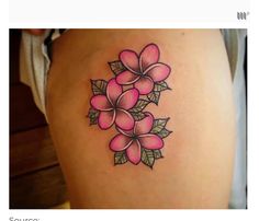 a woman's thigh with pink flowers on it