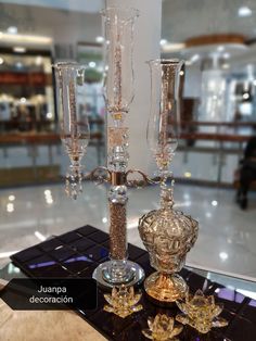 three crystal candlesticks are sitting on a table