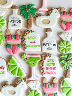 decorated cookies are arranged in the shape of palm trees and cocktails, including tequila