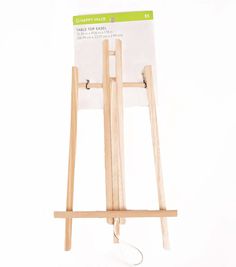 a wooden easel with a white sign on the front and back of it's stand