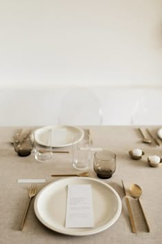 a table set with place settings and silverware