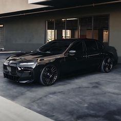 a black car parked in front of a building